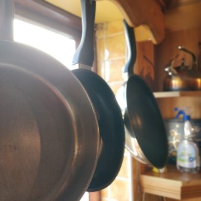 pans hanging in the window, showing the cooking facilities offered in our shared kitchen
