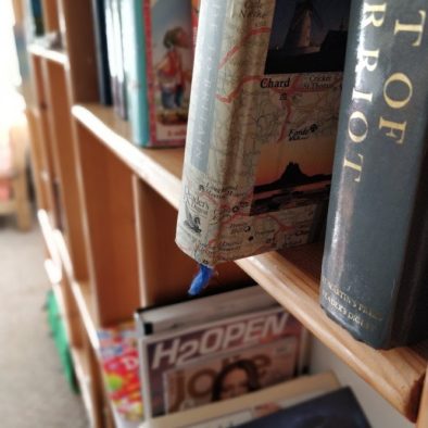 A picture featuring a close up of one of the many book shelfs laid about
