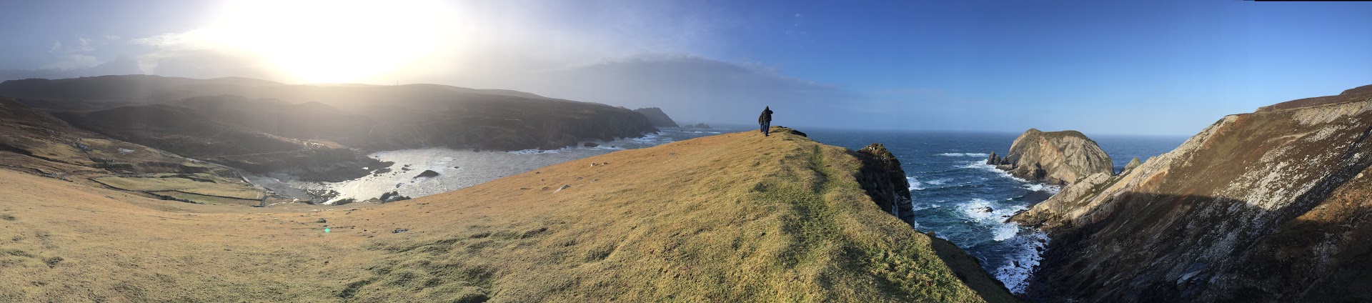 A scenic panoramic photo of a hillside dropping into the ocean at Port in Donegal