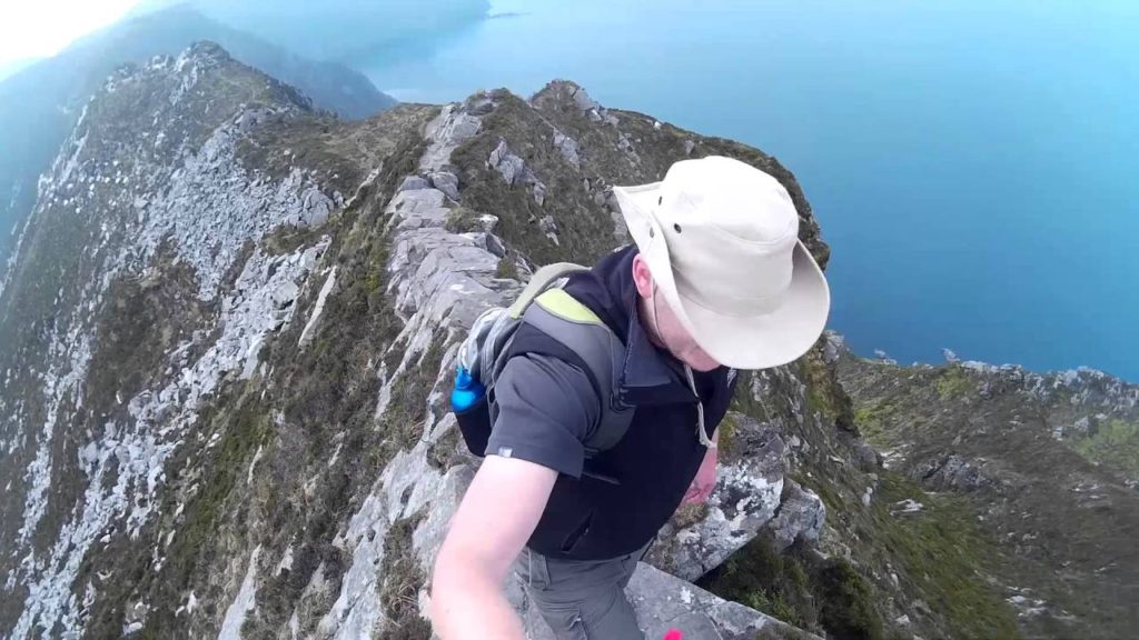 Man hiking the top of One Mans Pass